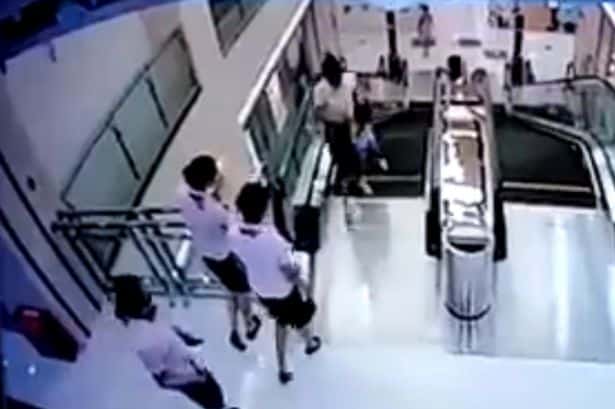 Mother_throws_son_to_safety_before_falling_to_death_in_escalator_horror
