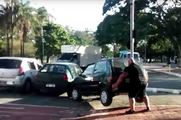 Watch_incredible_moment_angry_cyclist_lifts_CAR_out_of_bike_lane_as_pedestrians_cheer_wildly